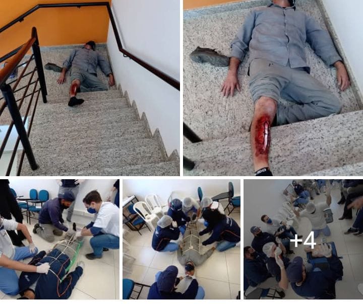 Treinamento prático de primeiros socorros e brigada de emergência, com simulação de resgate em escada e atendimento a vítima com ferimento.